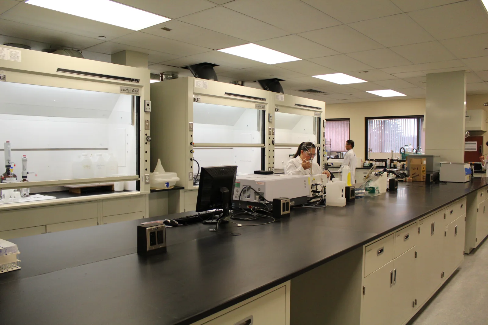 Laboratory with fume hoods, casework, and analytical equipment